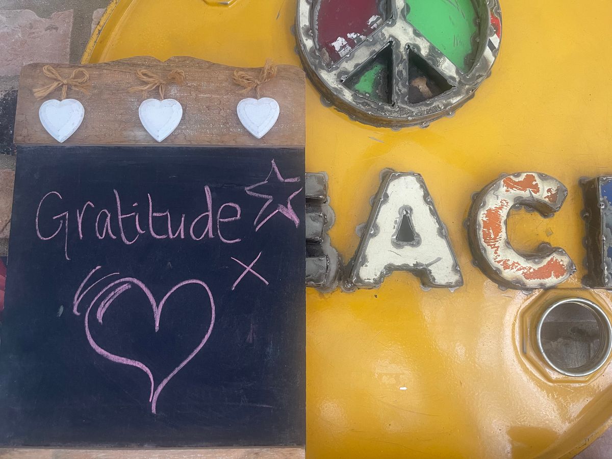 Gratitude written on a chalkboard against a weathered industrial background